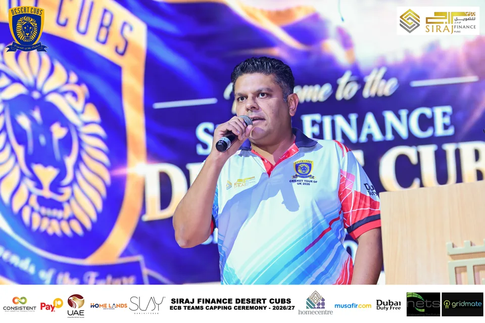 Speaker on stage at the Desert Cubs ECB capping ceremony — photograph 6943