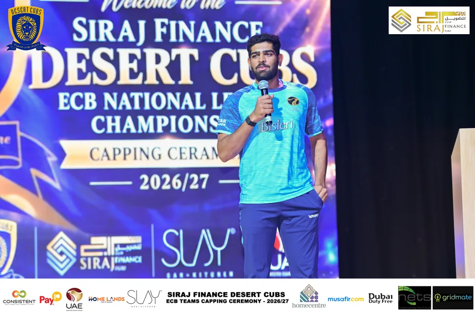 Speaker on stage at the Desert Cubs ECB capping ceremony — photograph 6953