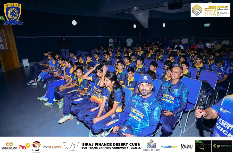 Players and attendees in the auditorium at the Desert Cubs capping ceremony — photograph 7039