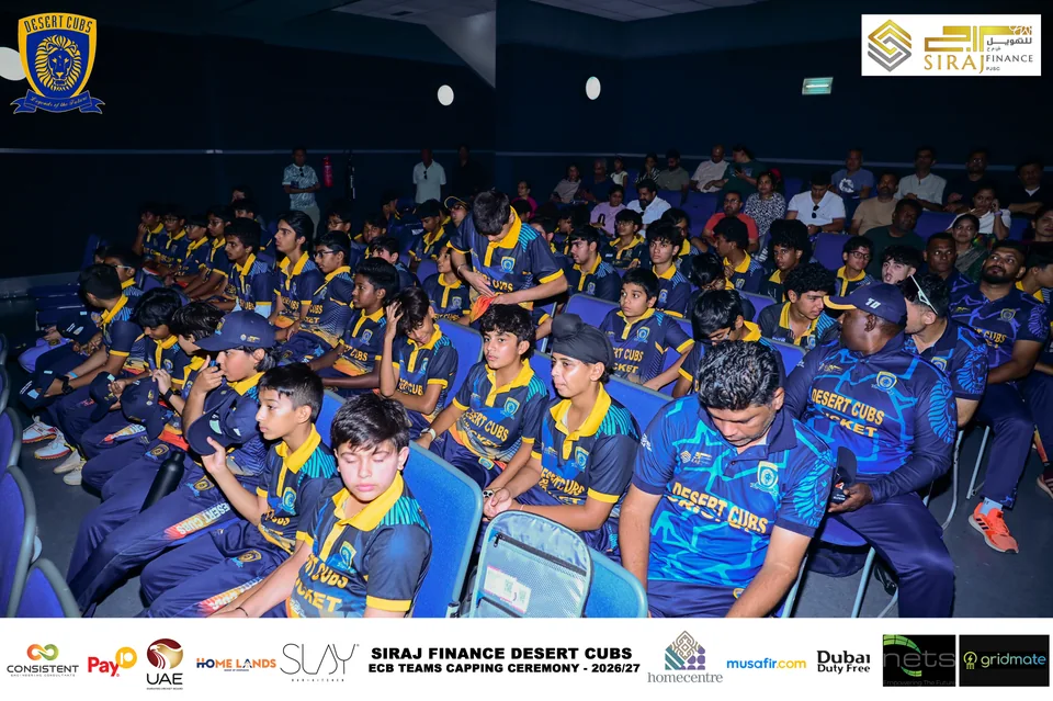 Players and attendees in the auditorium at the Desert Cubs capping ceremony — photograph 7272