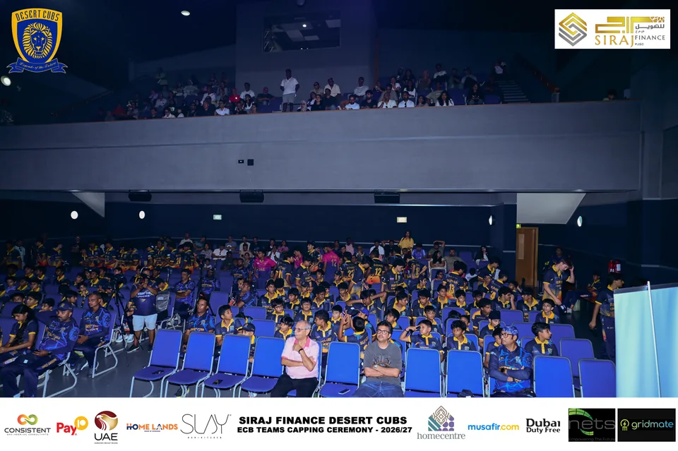 Players and attendees in the auditorium at the Desert Cubs capping ceremony — photograph 7514