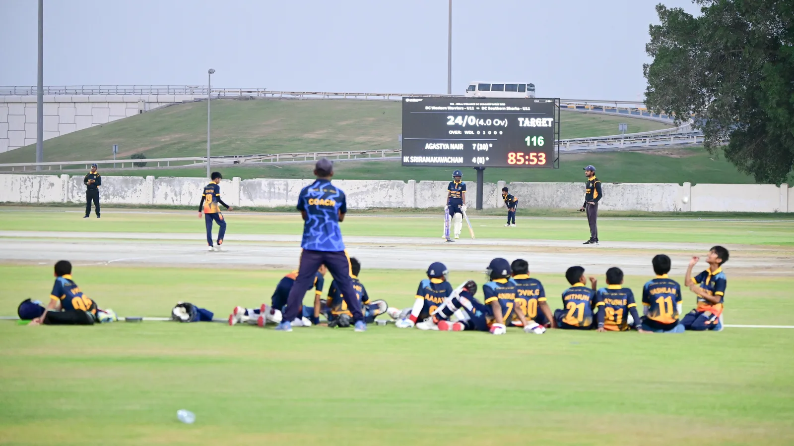 Junior cricketers and coaches during a centre-wicket match at Sharjah English School