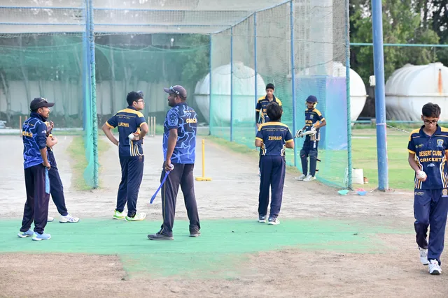 SES coach organising a junior group session beside the practice nets